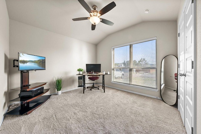 carpeted home office with vaulted ceiling, ceiling fan, and baseboards