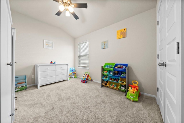 playroom featuring ceiling fan, carpet, baseboards, and lofted ceiling