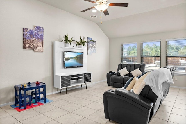 living area with a ceiling fan, plenty of natural light, lofted ceiling, and light tile patterned floors