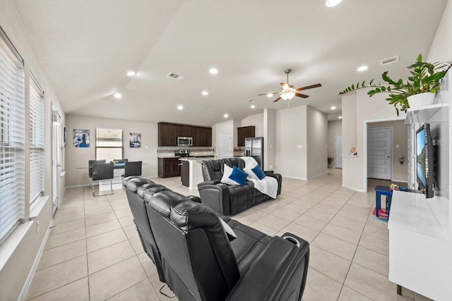 living room with lofted ceiling, light tile patterned floors, baseboards, ceiling fan, and recessed lighting