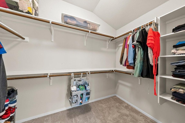 spacious closet featuring carpet flooring and lofted ceiling