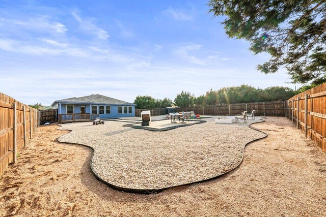 fenced backyard with a patio area