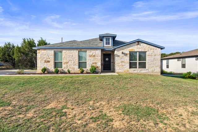 21604 Bluejay Blvd, Lago Vista, TX 78645 - view of front of house with stone siding and a front lawn