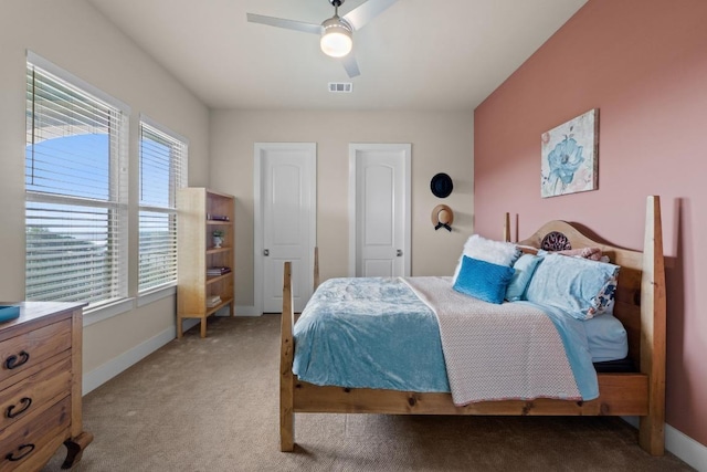 bedroom with carpet floors, visible vents, and baseboards