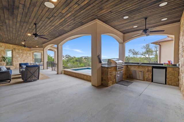view of patio / terrace with grilling area, an outdoor kitchen, a sink, and ceiling fan