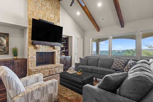 living area with high vaulted ceiling, a stone fireplace, beamed ceiling, visible vents, and recessed lighting