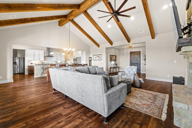 living area with dark wood-style floors, beamed ceiling, baseboards, high vaulted ceiling, and ceiling fan with notable chandelier