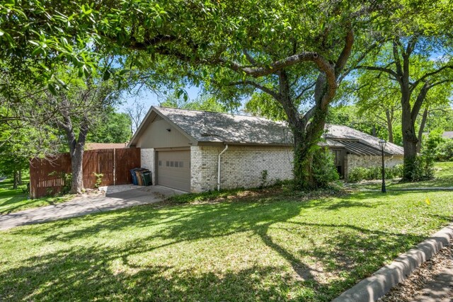11525 Spring Hill Dr, Austin, TX 78753 - view of property exterior featuring brick siding, an attached garage, and concrete driveway