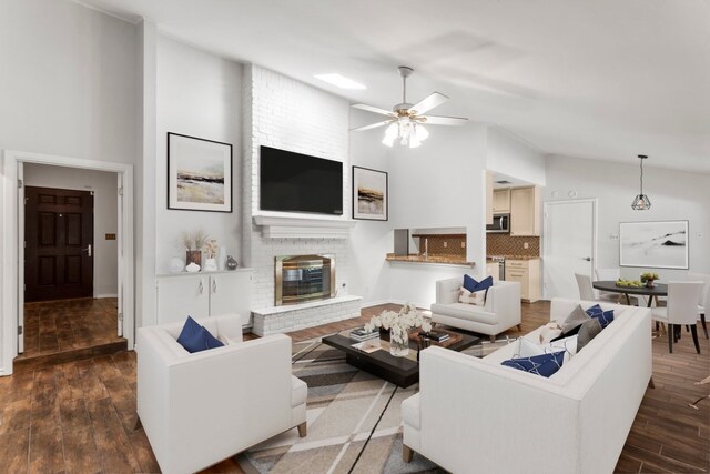 11525 Spring Hill Dr, Austin, TX 78753 - living area featuring a brick fireplace, dark wood finished floors, ceiling fan, and high vaulted ceiling