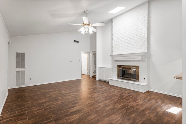 11525 Spring Hill Dr, Austin, TX 78753 - unfurnished living room featuring a fireplace, wood finished floors, ceiling fan, baseboards, and high vaulted ceiling