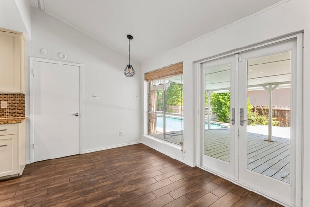 11525 Spring Hill Dr, Austin, TX 78753 - unfurnished dining area featuring lofted ceiling, dark wood-style flooring, french doors, baseboards, and crown molding