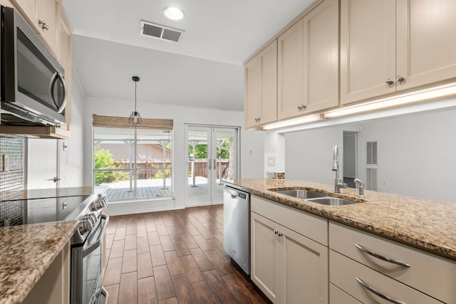 11525 Spring Hill Dr, Austin, TX 78753 - kitchen featuring stainless steel appliances, a sink, dark wood finished floors, french doors, and light stone counters