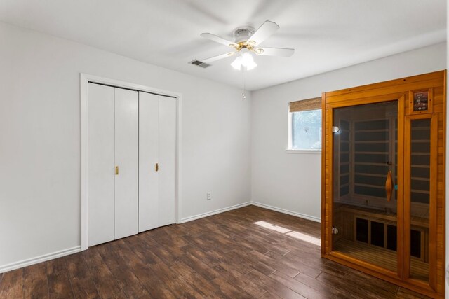 11525 Spring Hill Dr, Austin, TX 78753 - unfurnished bedroom with a closet, dark wood-style floors, baseboards, and ceiling fan