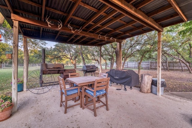 view of patio / terrace with fence, grilling area, and outdoor dining space