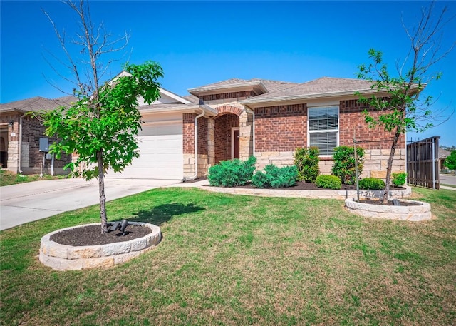 369 Empress Tree Dr, Leander, TX 78641 - view of front of home with concrete driveway, an attached garage, a front lawn, and stone siding