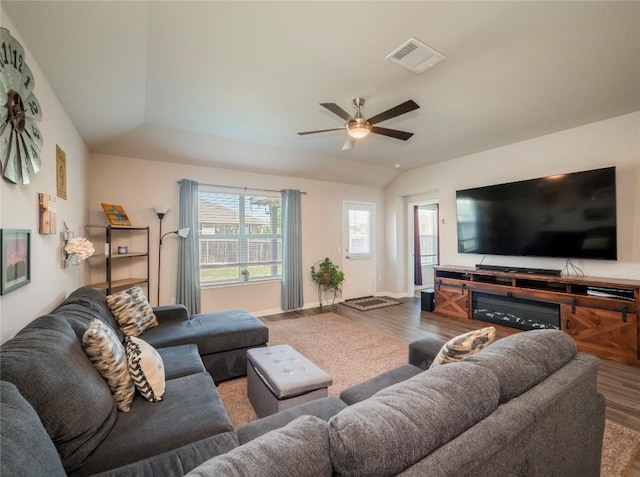 369 Empress Tree Dr, Leander, TX 78641 - living room featuring wood finished floors, vaulted ceiling, a ceiling fan, and baseboards