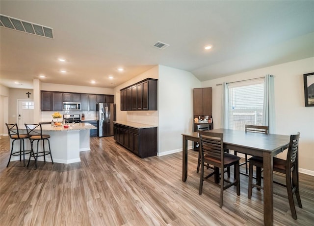 369 Empress Tree Dr, Leander, TX 78641 - dining space featuring wood finished floors, baseboards, and recessed lighting
