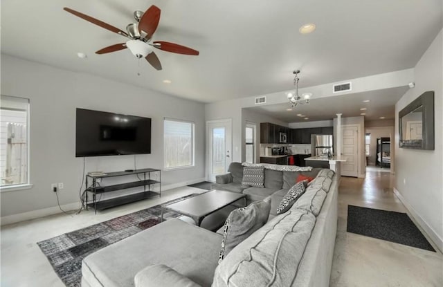 1302 E 3rd St, Austin, TX 78702 - living room with a chandelier, a ceiling fan, and recessed lighting