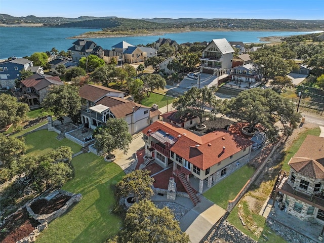 drone / aerial view with a water and mountain view and a residential view