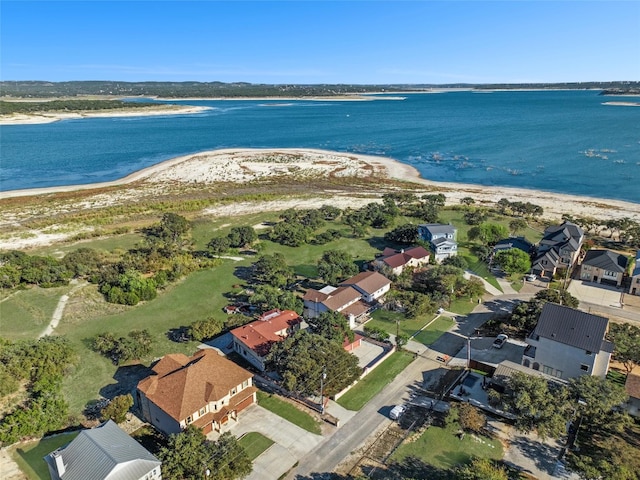 aerial view featuring a beach view, a water view, and a residential view