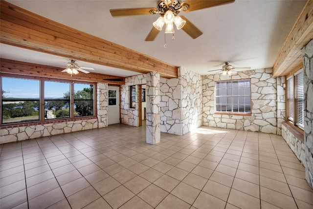 interior space featuring plenty of natural light, a ceiling fan, and light tile patterned flooring