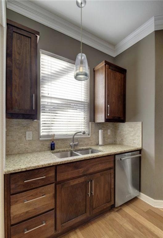 1621 Enfield Rd Unit B, Austin, TX 78703 - kitchen featuring stainless steel dishwasher, light wood-type flooring, tasteful backsplash, decorative light fixtures, and crown molding