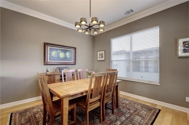 1621 Enfield Rd Unit B, Austin, TX 78703 - dining area featuring a chandelier, ornamental molding, and light wood finished floors