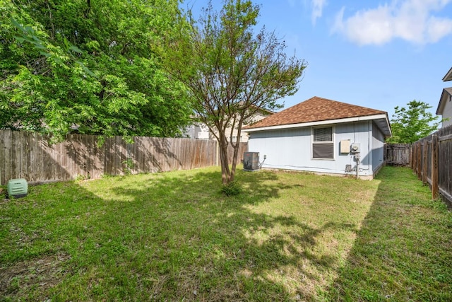 view of yard featuring a fenced backyard and central air condition unit
