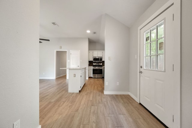 foyer entrance featuring light wood finished floors, baseboards, recessed lighting, and visible vents