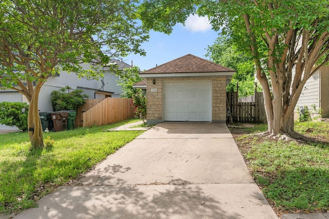 detached garage with driveway and fence