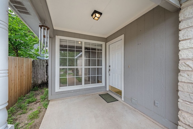 doorway to property with fence