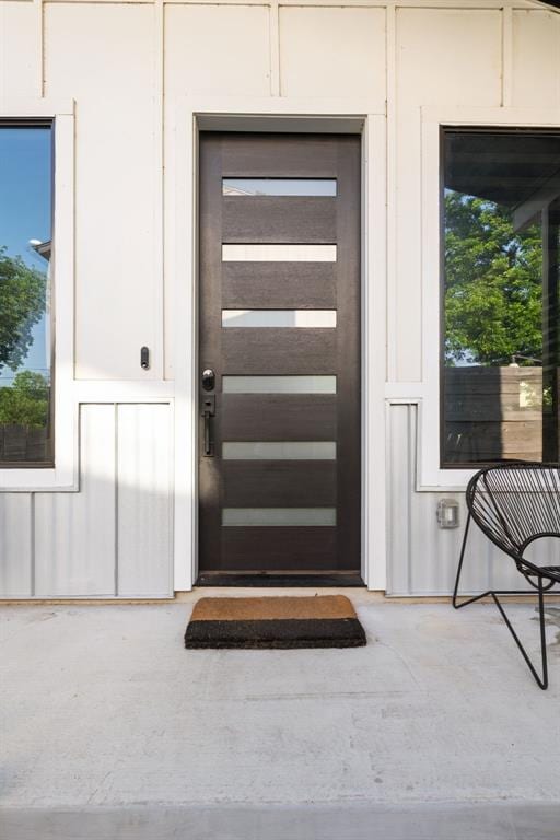 view of exterior entry with board and batten siding