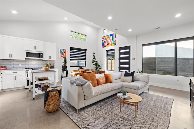living area featuring recessed lighting, visible vents, and finished concrete floors