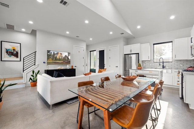 dining space with recessed lighting, visible vents, and finished concrete flooring