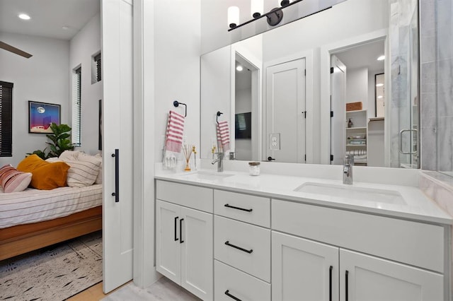 bathroom featuring ensuite bathroom, a sink, double vanity, and a stall shower