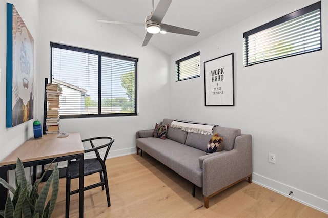living room with ceiling fan, baseboards, lofted ceiling, and light wood-style flooring