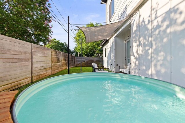 view of pool with a fenced backyard
