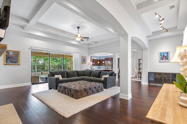 205 Bisset Ct, Austin, TX 78738 - living room with arched walkways, hardwood / wood-style floors, a ceiling fan, and beamed ceiling