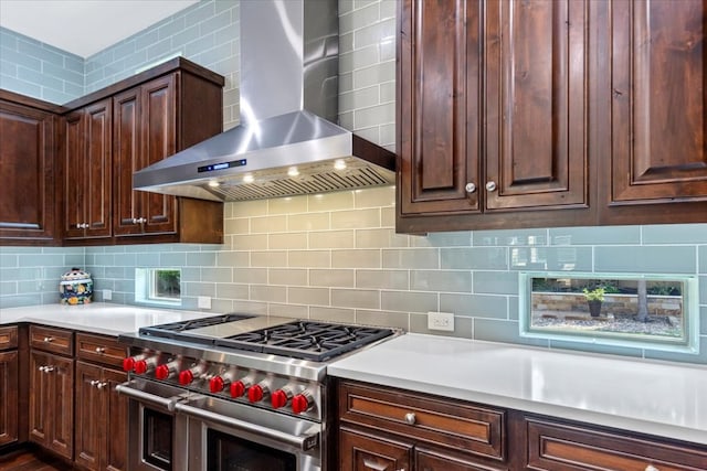 205 Bisset Ct, Austin, TX 78738 - kitchen featuring double oven range, wall chimney range hood, backsplash, light countertops, and dark brown cabinets