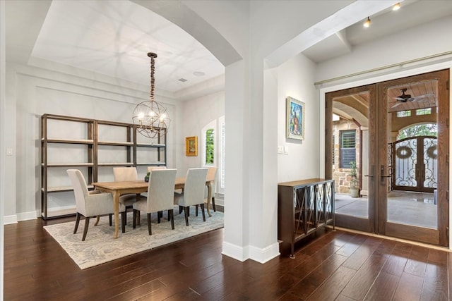 205 Bisset Ct, Austin, TX 78738 - dining area featuring dark wood-type flooring, arched walkways, a chandelier, and french doors