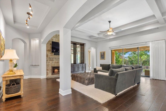 205 Bisset Ct, Austin, TX 78738 - living area with arched walkways, hardwood / wood-style floors, coffered ceiling, a ceiling fan, and a stone fireplace