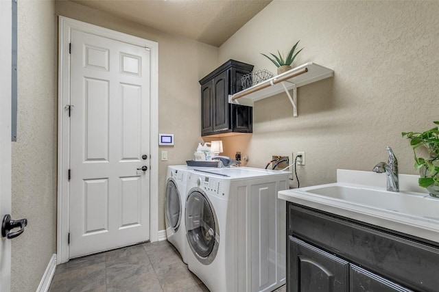 29047 Hobblebush, San Antonio, TX 78260 - laundry area featuring washing machine and dryer, cabinet space, and a textured wall