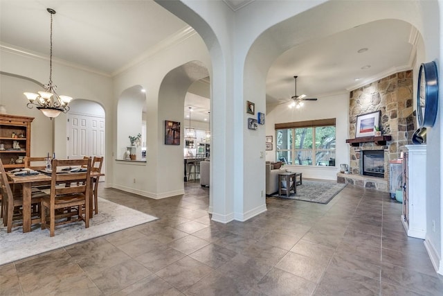 29047 Hobblebush, San Antonio, TX 78260 - dining room featuring ceiling fan, crown molding, a fireplace, arched walkways, and a chandelier