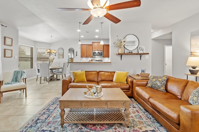 19000 Obed River Dr, Pflugerville, TX 78660 - living area featuring light tile patterned flooring, vaulted ceiling, baseboards, visible vents, and ceiling fan with notable chandelier