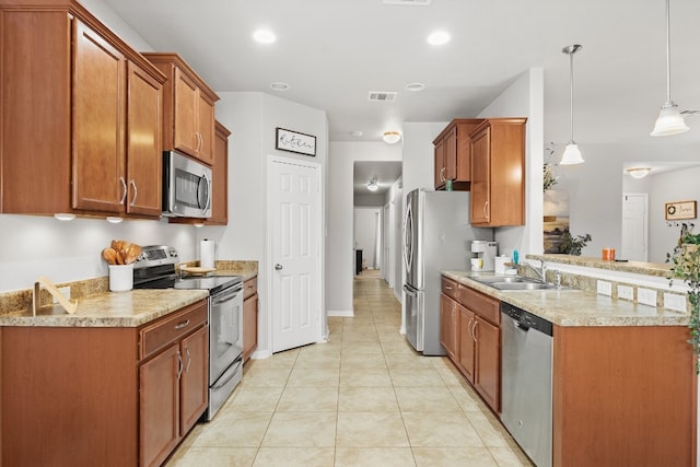 19000 Obed River Dr, Pflugerville, TX 78660 - kitchen featuring stainless steel appliances, light countertops, brown cabinets, light tile patterned flooring, and decorative light fixtures