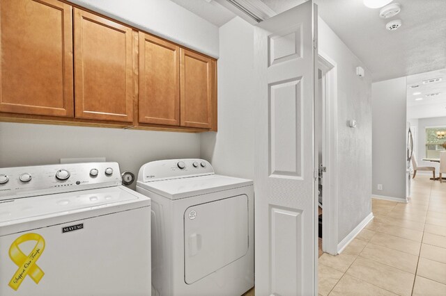 19000 Obed River Dr, Pflugerville, TX 78660 - laundry room with separate washer and dryer, baseboards, light tile patterned floors, and cabinet space
