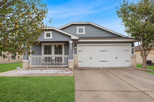 19000 Obed River Dr, Pflugerville, TX 78660 - view of front facade with a front lawn, central AC, concrete driveway, covered porch, and a garage