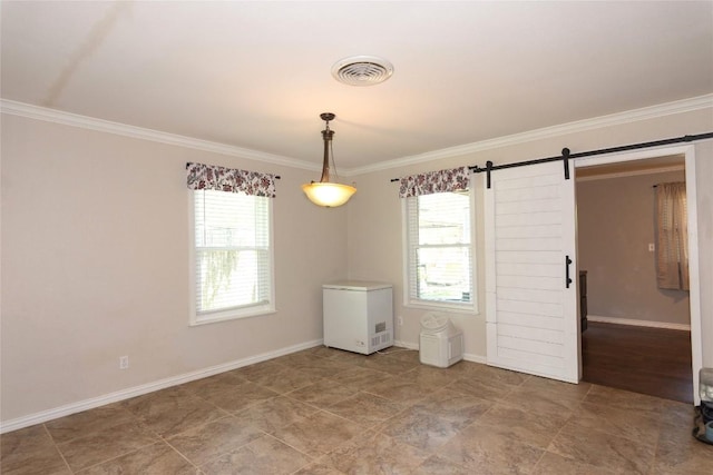 1212 Lake Terrace Dr, Elgin, TX 78621 - spare room with a barn door, visible vents, crown molding, and a healthy amount of sunlight