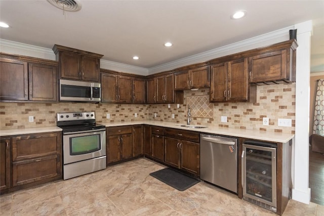 1212 Lake Terrace Dr, Elgin, TX 78621 - kitchen with a sink, visible vents, dark brown cabinetry, beverage cooler, and appliances with stainless steel finishes