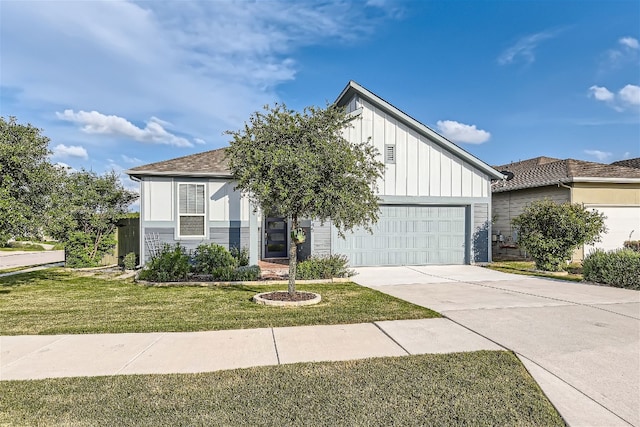 9945 Comely Bnd, Manor, TX 78653 - view of front facade featuring board and batten siding, driveway, a front yard, and a garage